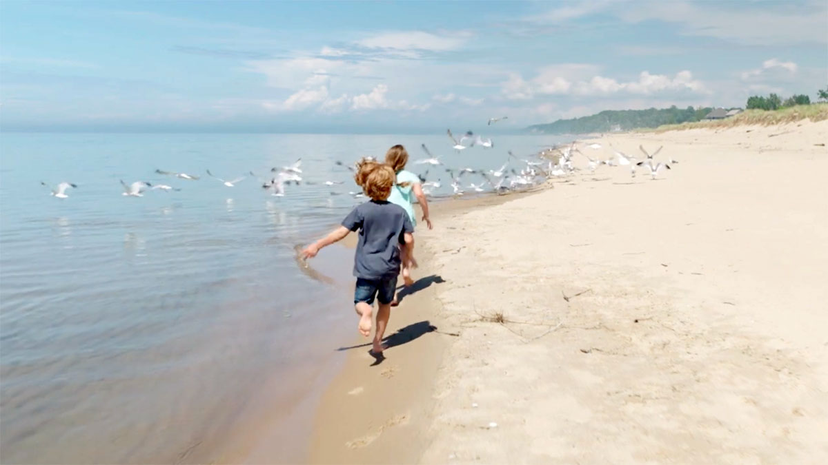 Children running on the shore of Lake Michigan, Whirlpool Corporation's headquarters.